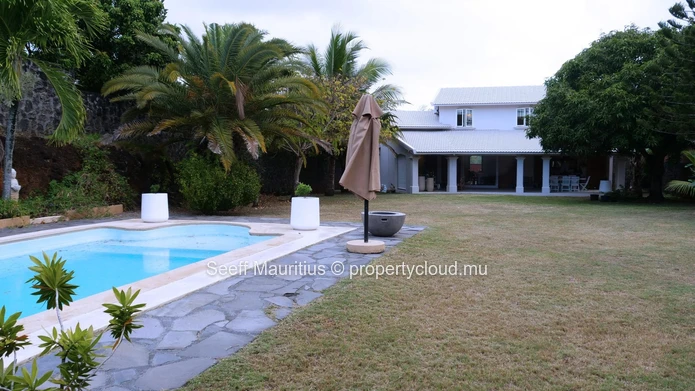 A home with a large garden that breathes elegance.
